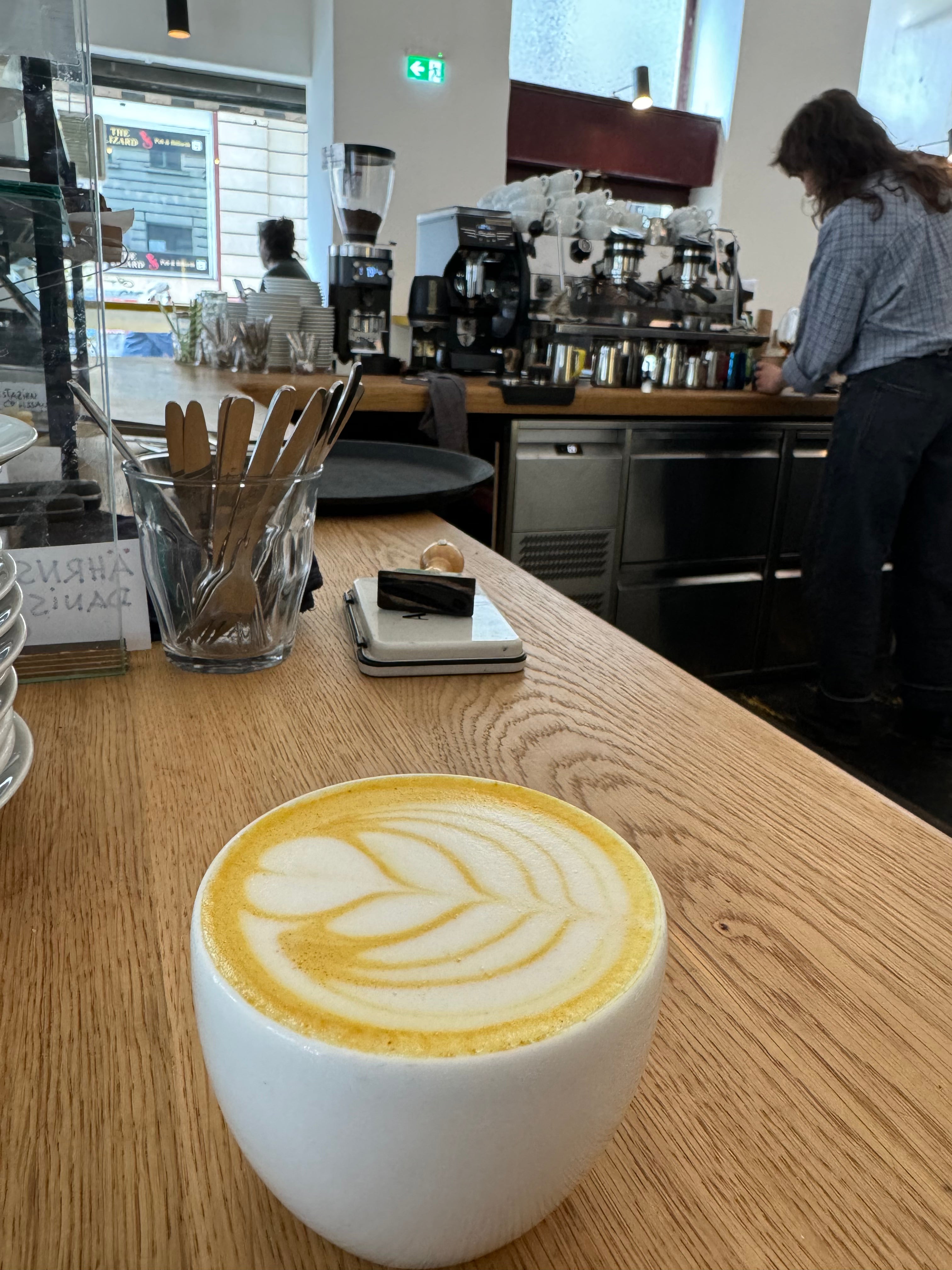 Cup of Good Day Latte Turmeric Latte on counter at coffee shop
